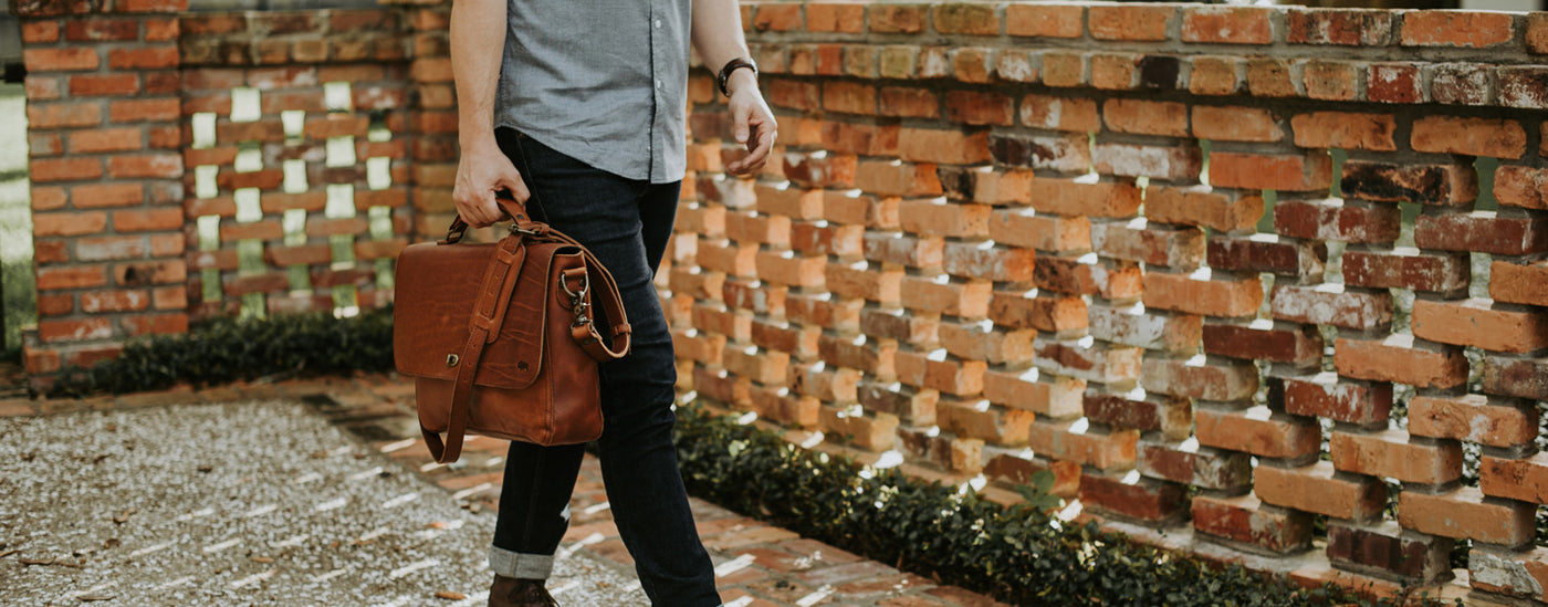 Man Carrying rugged leather briefcase bag
