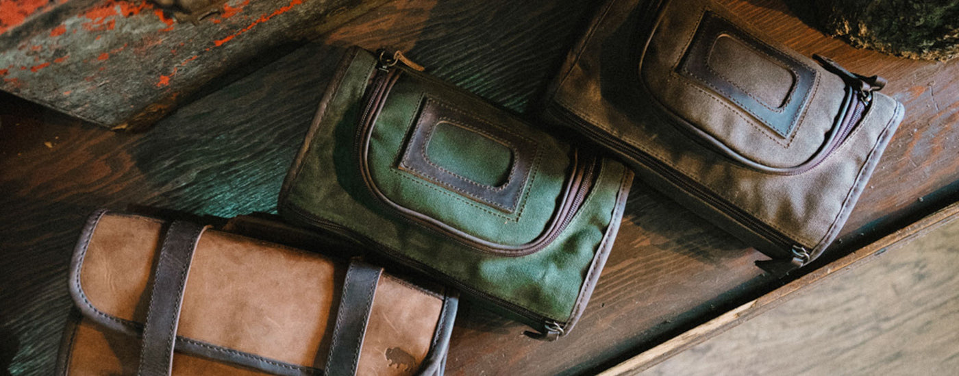 An assortment of three leather dopp kits.