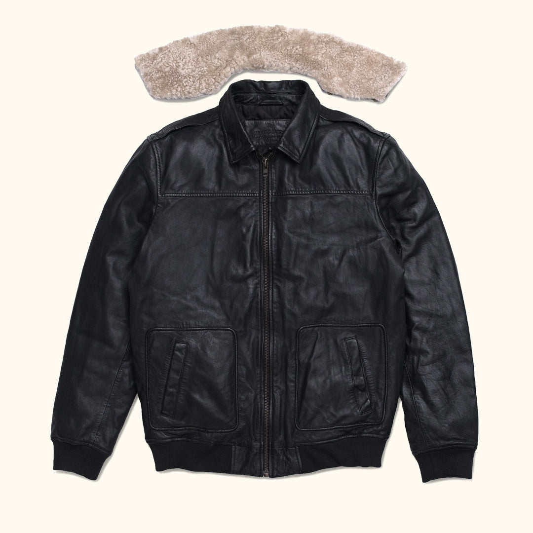 Versatile black leather jacket with front pockets, paired with a removable shearling collar.