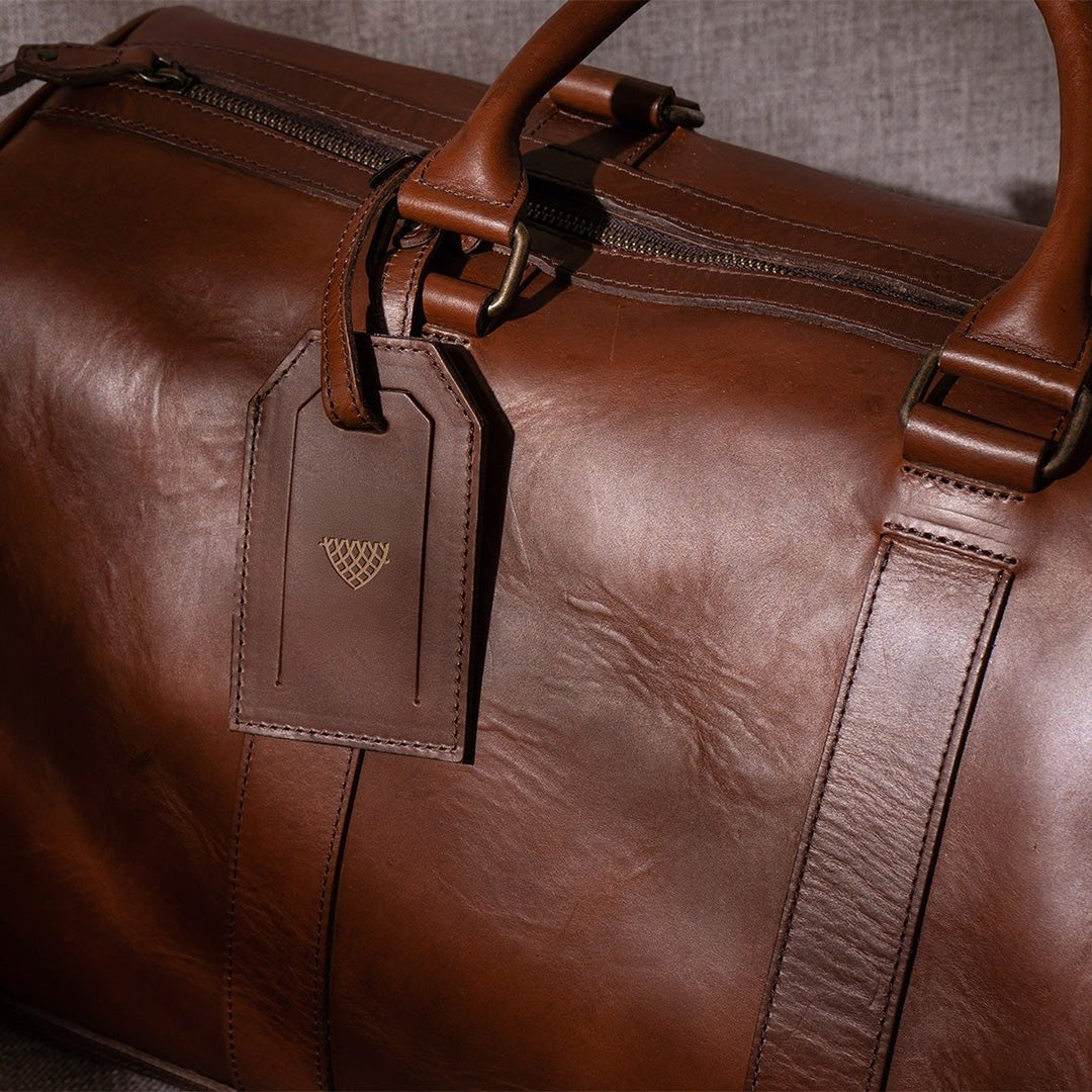 Sophisticated leather carryall, ideal for travel, with ample space, secure zippers, and a timeless design.