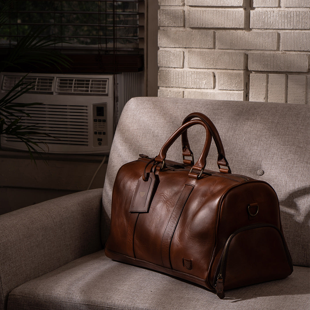Sophisticated leather carryall, ideal for travel, with ample space, secure zippers, and a timeless design.