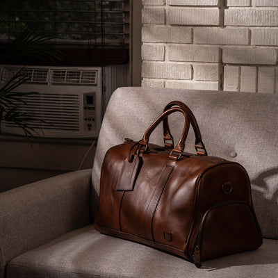 Sophisticated leather carryall, ideal for travel, with ample space, secure zippers, and a timeless design.