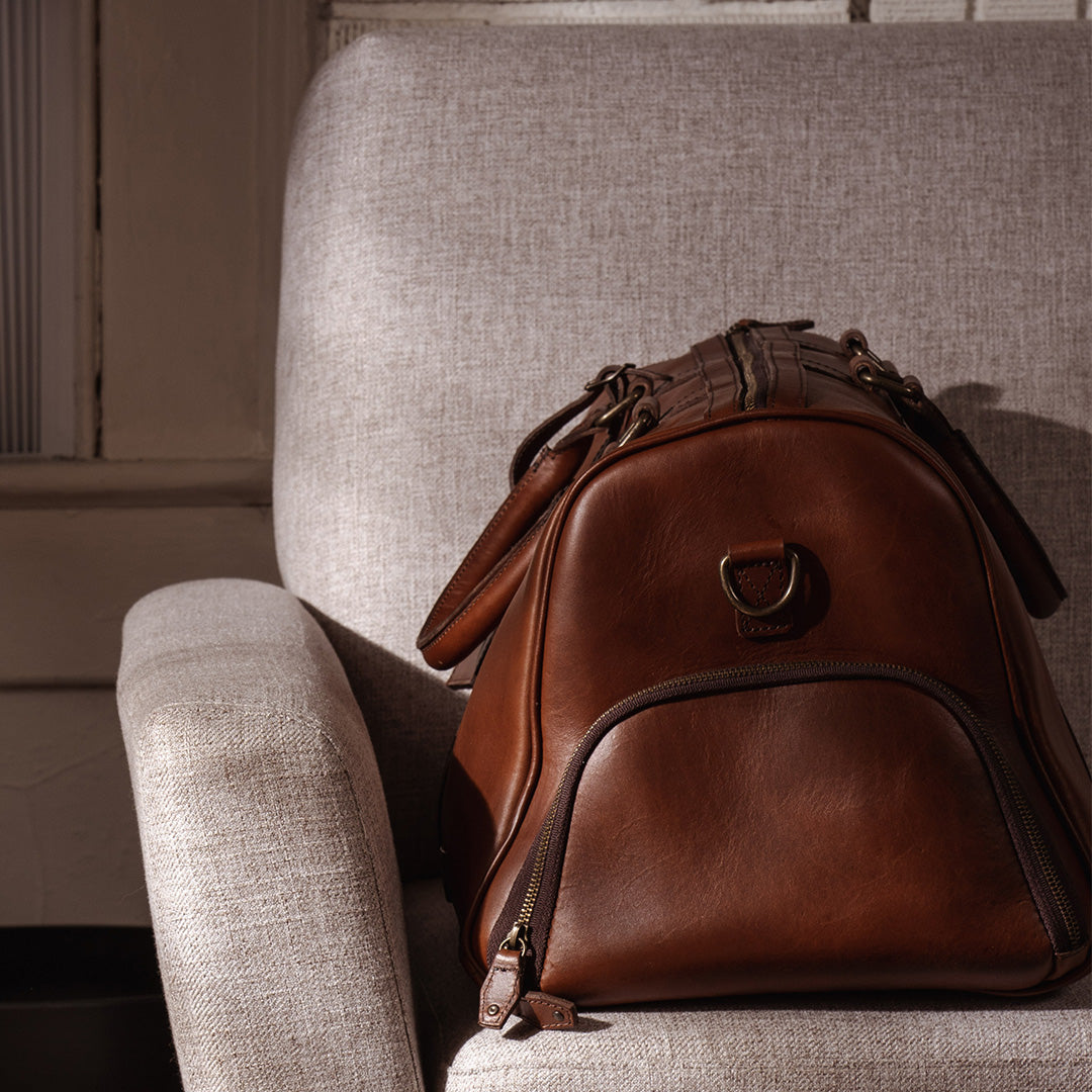 Sophisticated leather carryall, ideal for travel, with ample space, secure zippers, and a timeless design.