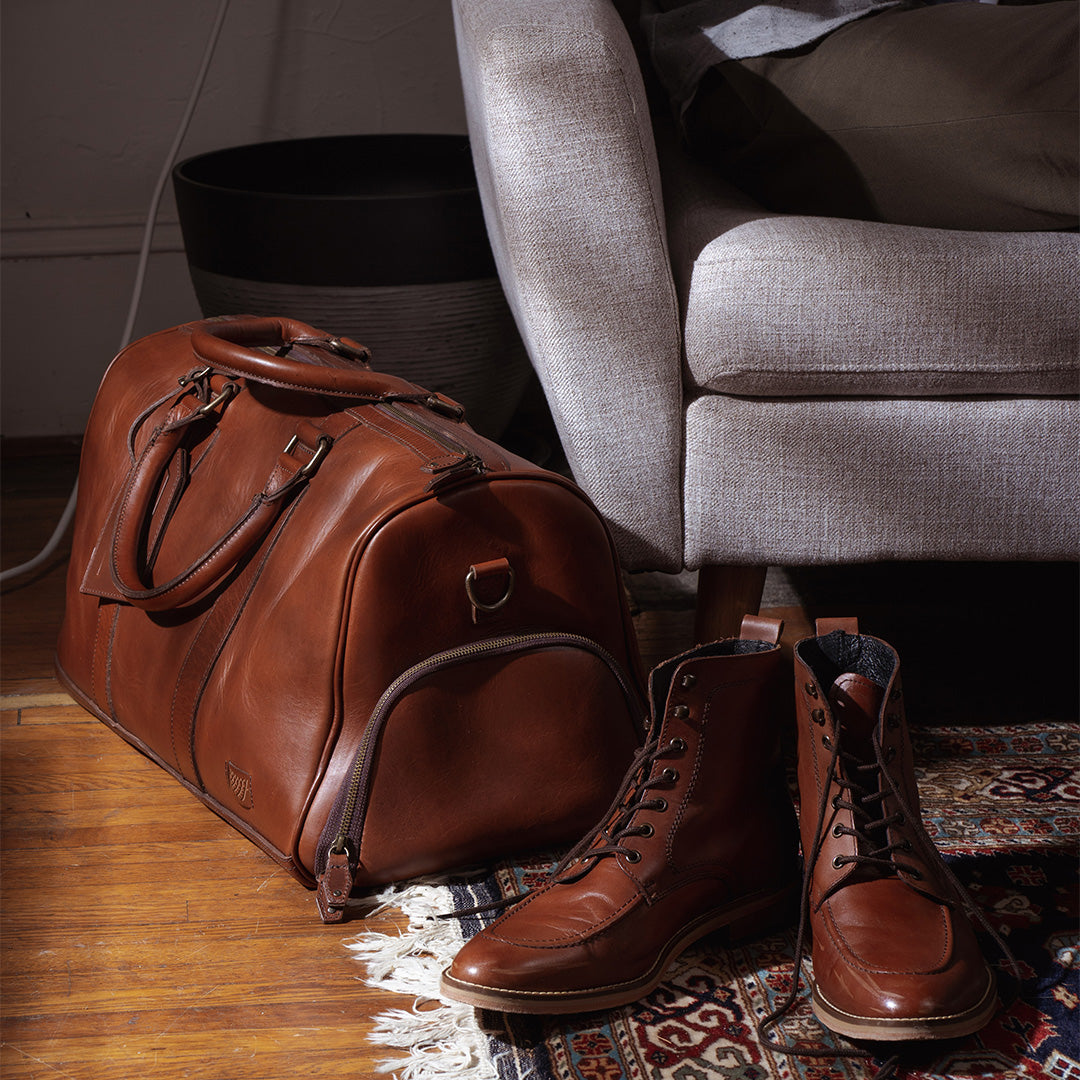Sophisticated leather carryall, ideal for travel, with ample space, secure zippers, and a timeless design.