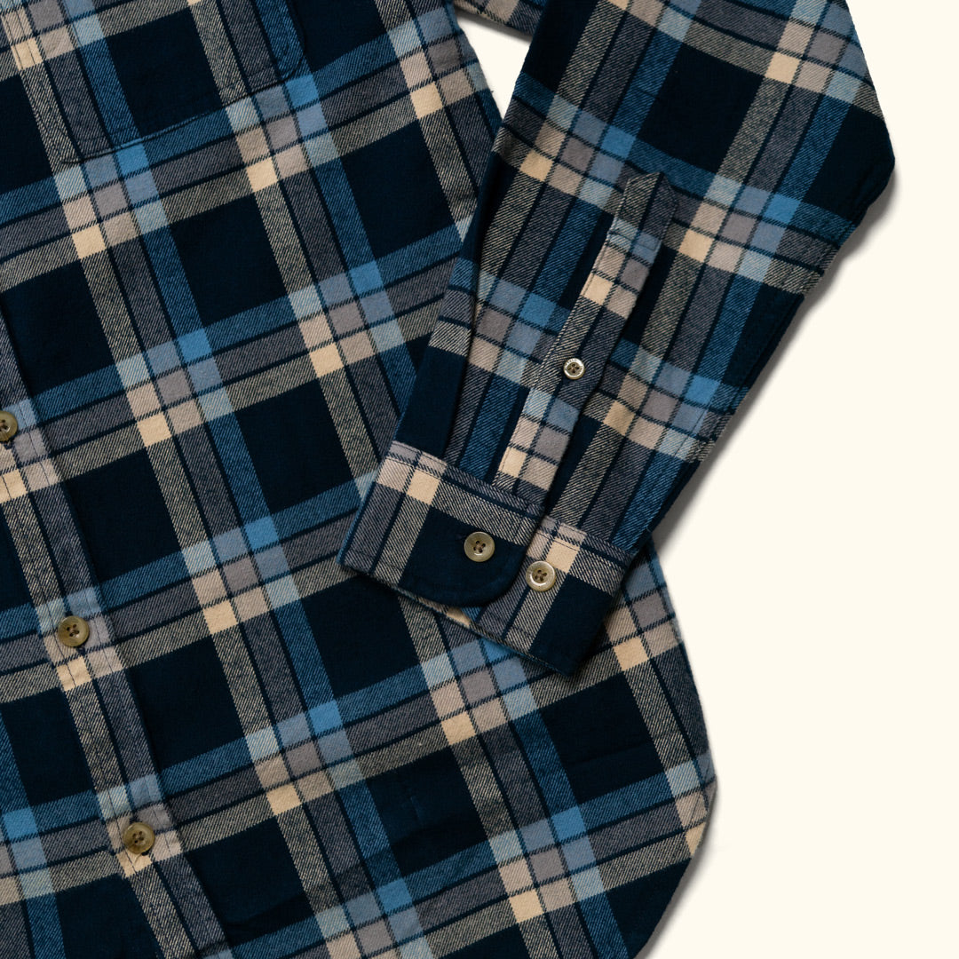 Detail of sleeve and cuff of Fairbanks Flannel Shirt – rugged finish and stout buttons in navy lake plaid design