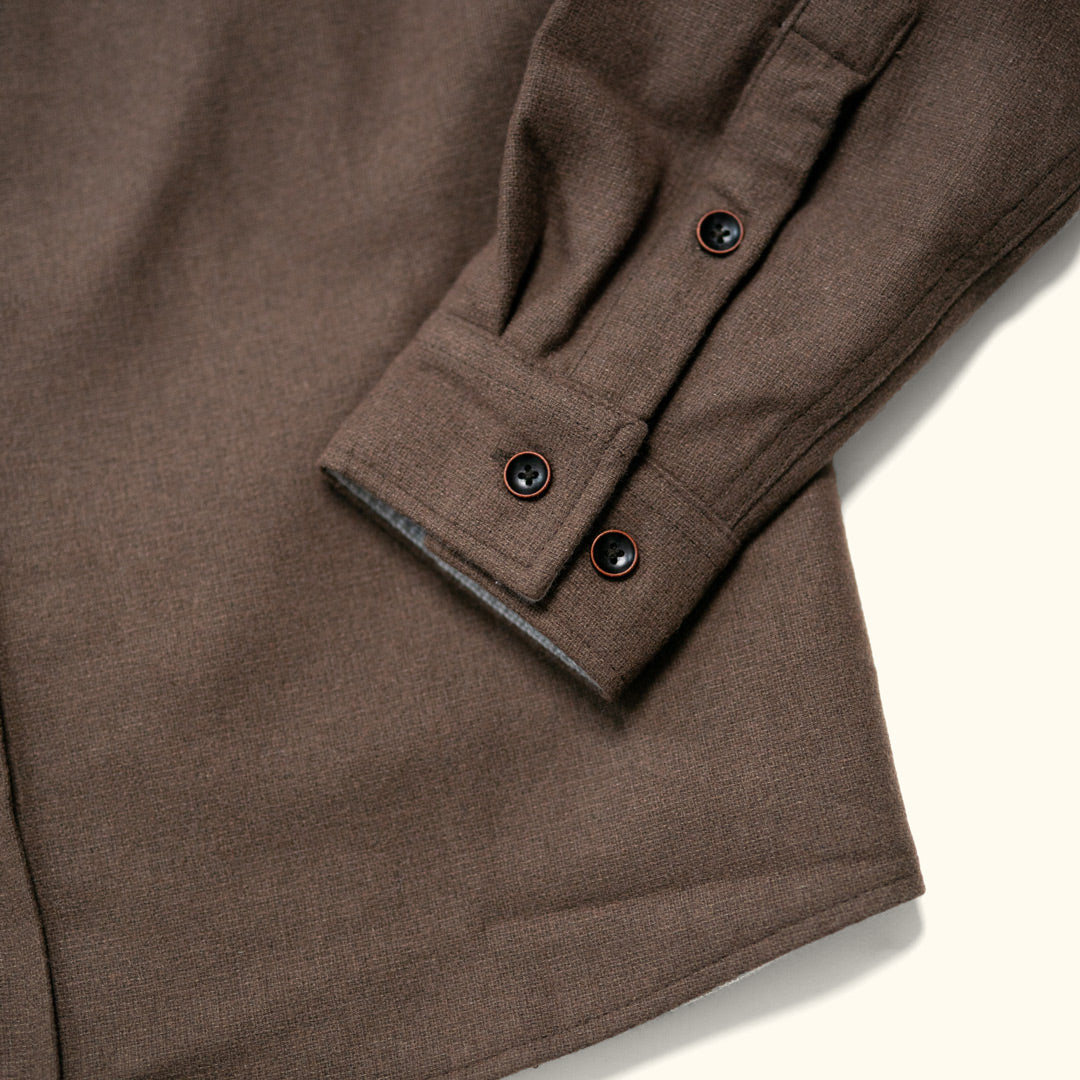Detail of cuff, sleeve and wood buttons on brown Gunnison wool blend flannel shirt showing artisanal finish