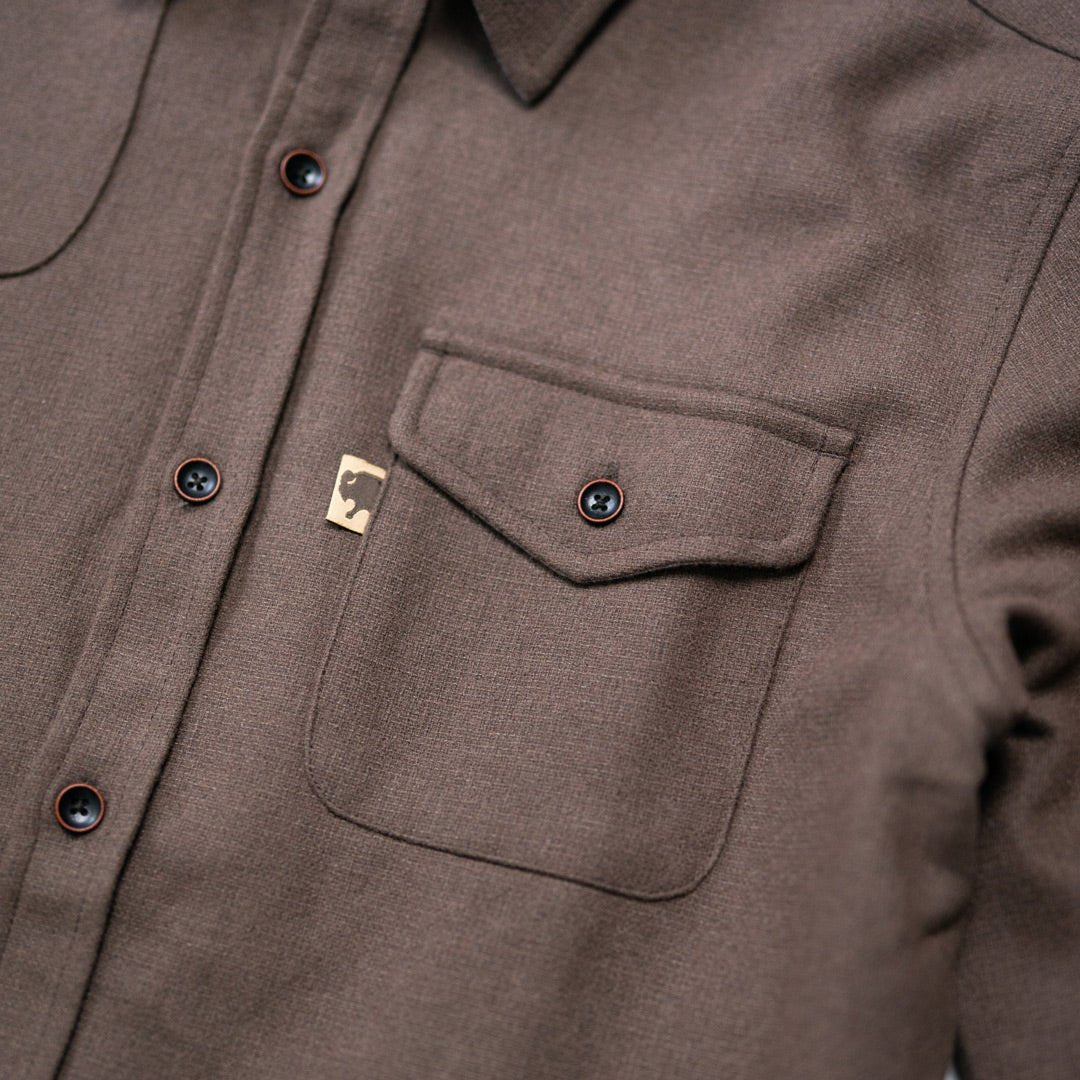 Close texture shot of Gunnison brown wool-blend flannel revealing fabric weave, soft nap, and rugged durability