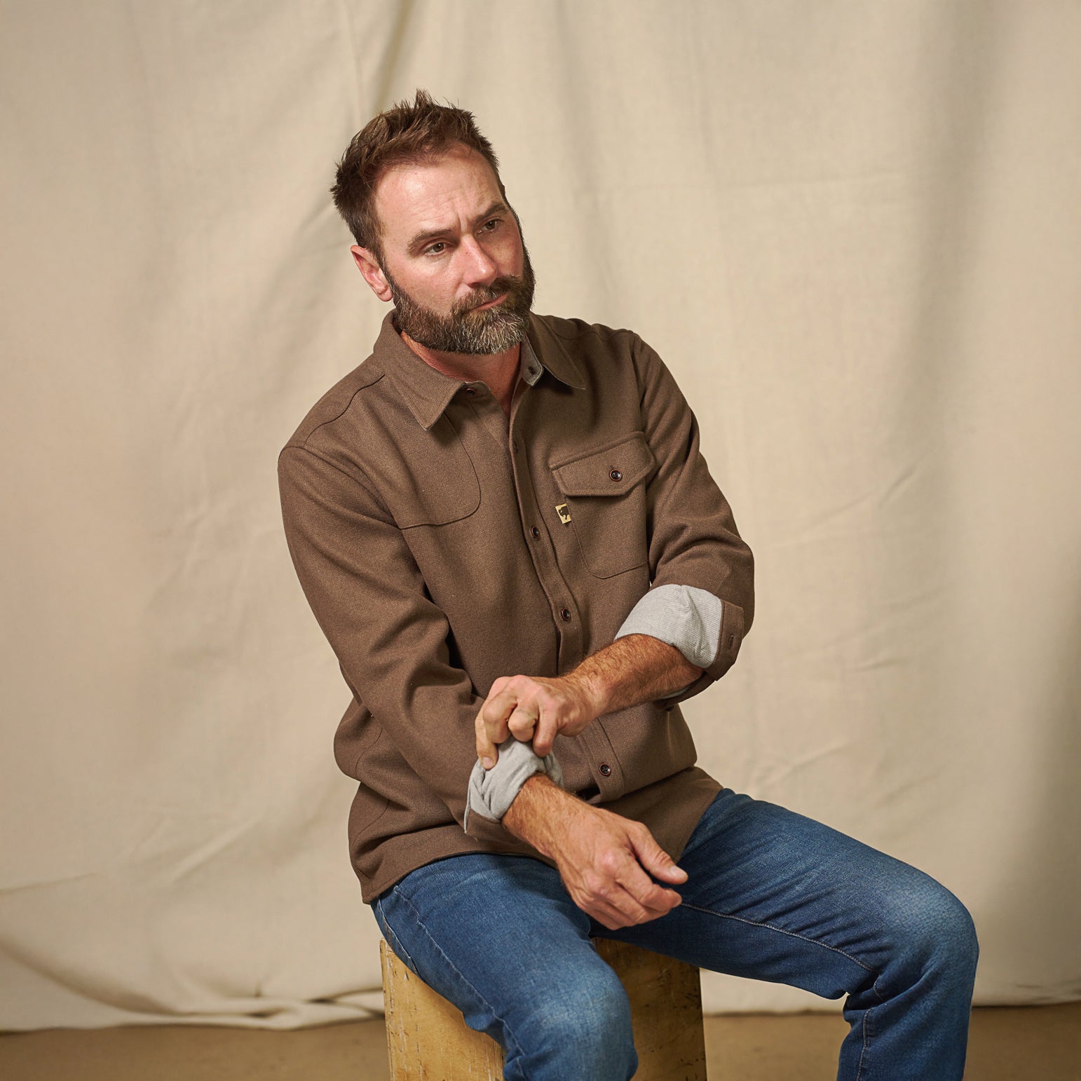 Styled outdoors photo of Gunnison brown wool-blend solid flannel shirt paired with jeans – rugged fall fashion look