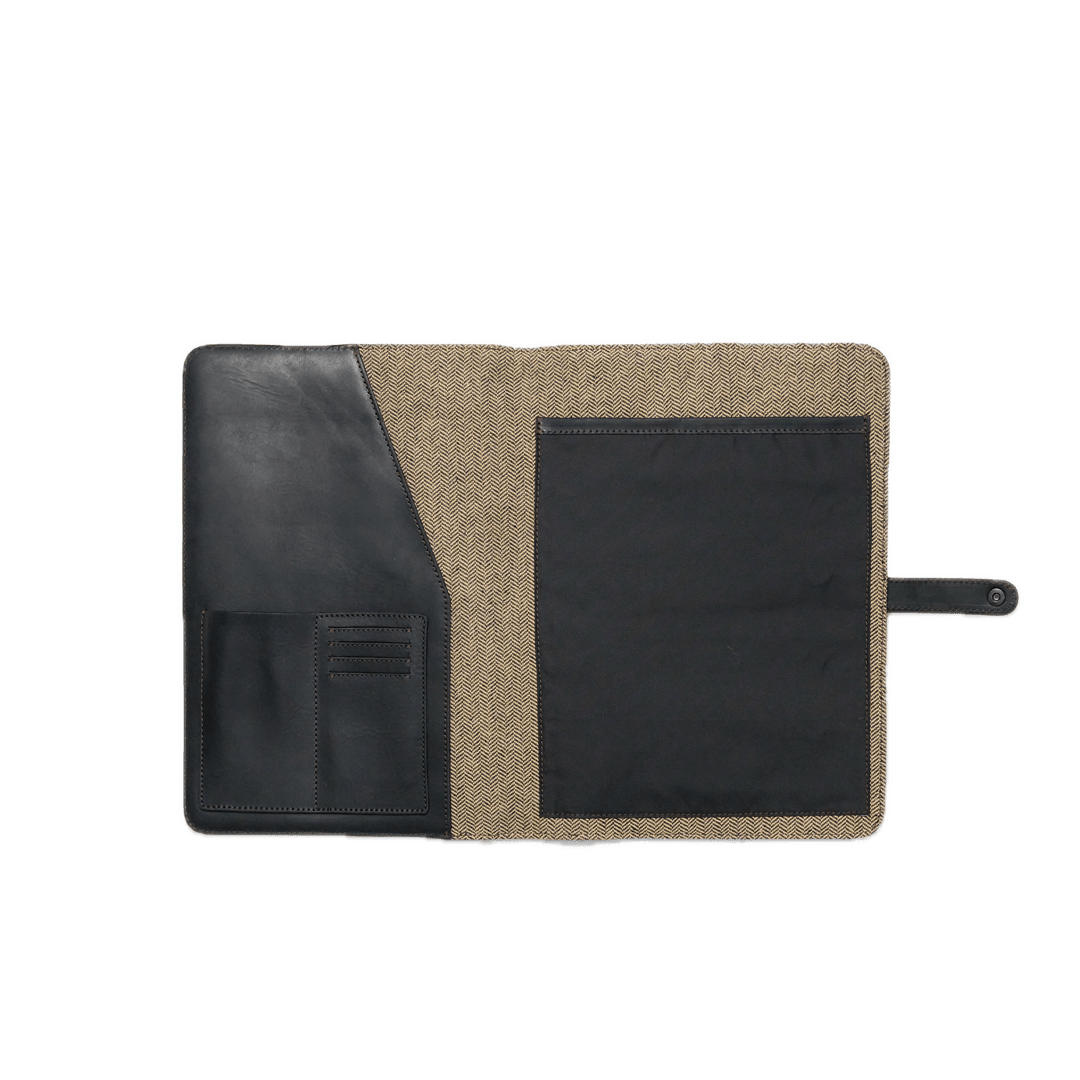 Two-tone leather and fabric pouch with a black flap on a white background