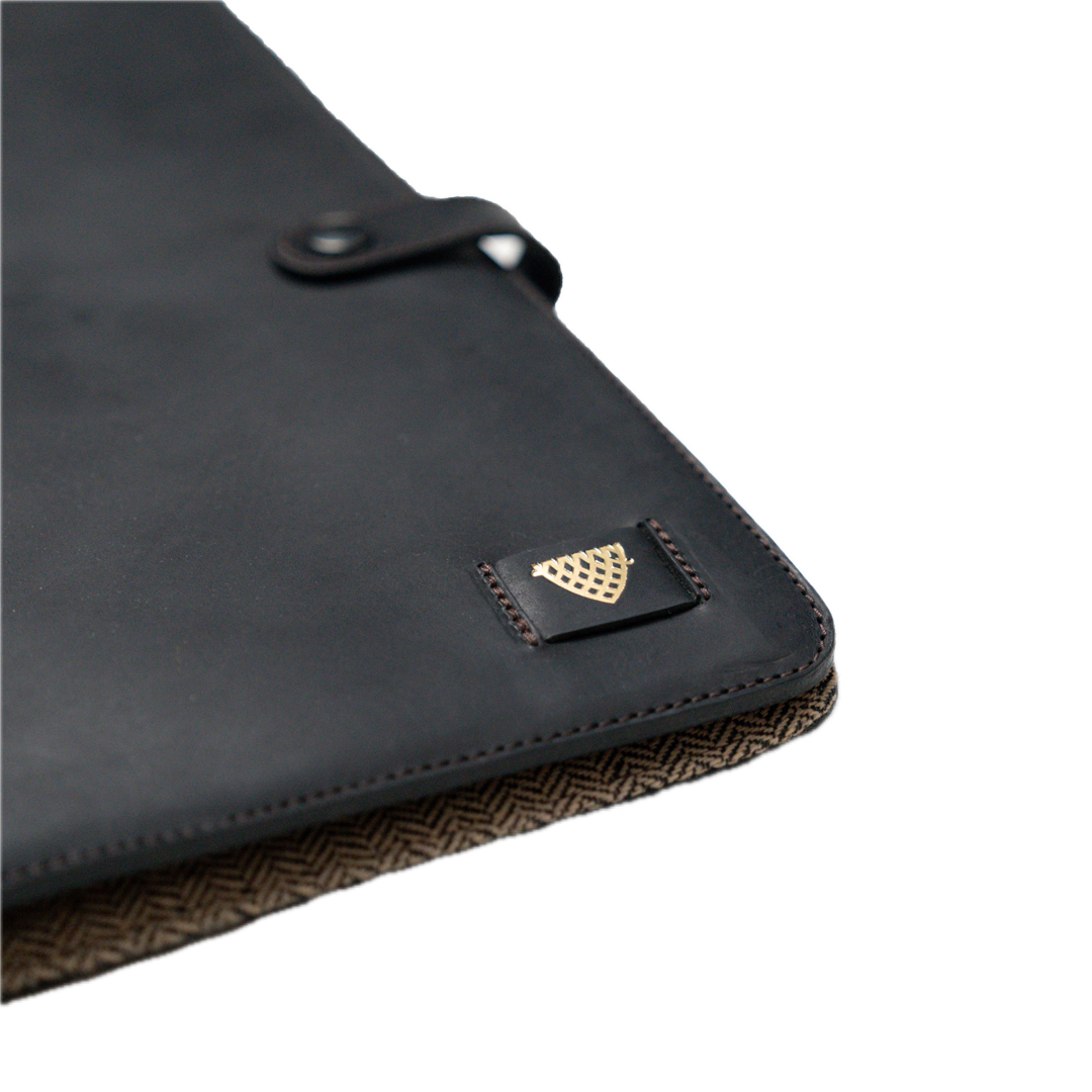 Black leather case with a brand logo on a white background