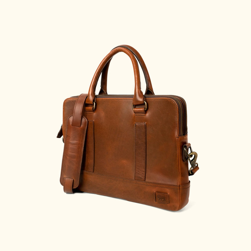 Sleek brown leather attache bag with elegant handles and strap.