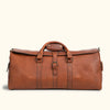 Vintage-inspired brown leather travel duffle with sturdy handles, adjustable strap, and secure buckles, ideal for outdoor adventures.