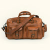 Roosevelt’s amber brown buffalo leather bag, perfect for travel with robust straps and several organizational pockets.