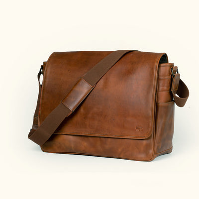 Luxurious large amber brown leather messenger bag, ideal for business or travel with stylish strap.