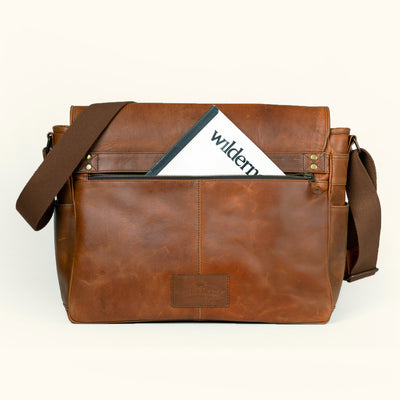 Durable large amber brown buffalo leather satchel with sleek design and multiple compartments.