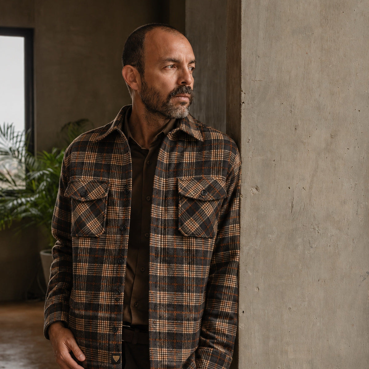 Man in the Aberdeen Wool Twill Shirt Jac in Brown Briar by a concrete column
