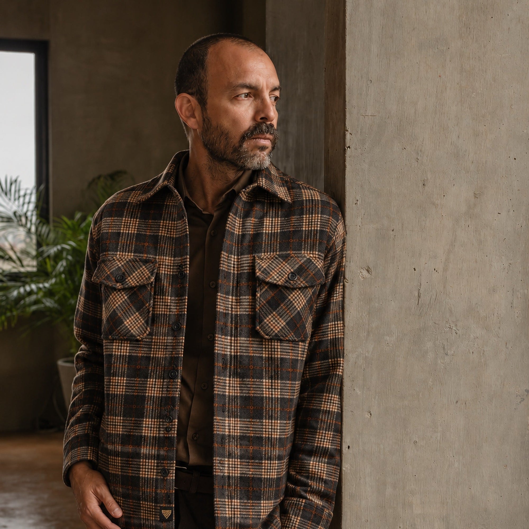 Man in the Aberdeen Wool Twill Shirt Jac in Brown Briar by a concrete column