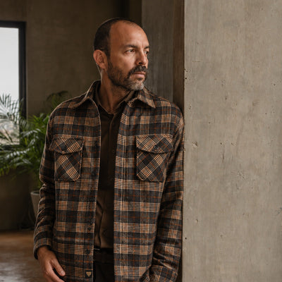 Man in the Aberdeen Wool Twill Shirt Jac in Brown Briar by a concrete column