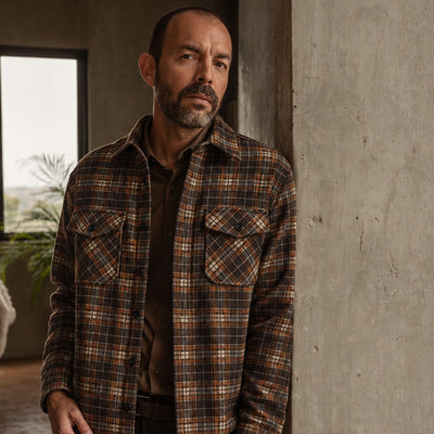Man in the Aberdeen Wool Twill Shirt Jac in Brown Briar leaning on a concrete column