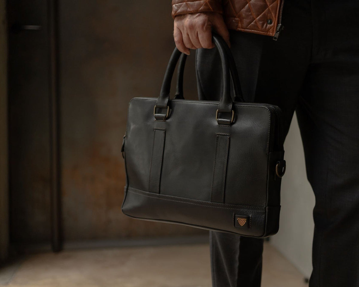 Jefferson Leather Briefcase in Vintage Black, carried by hand