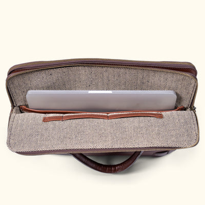 Computer fitting snugly inside a refined leather attache bag.