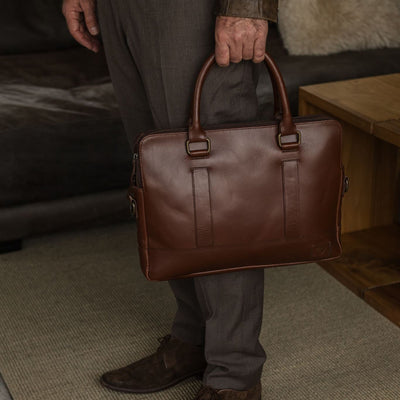 Man carrying the Jefferson Leather Attaché Briefcase in Elderwood Brown.