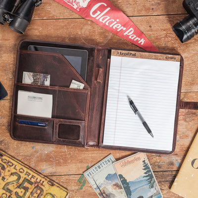 Professional dark oak leather padfolio with a classic design, featuring a secure strap closure and meticulous stitching.