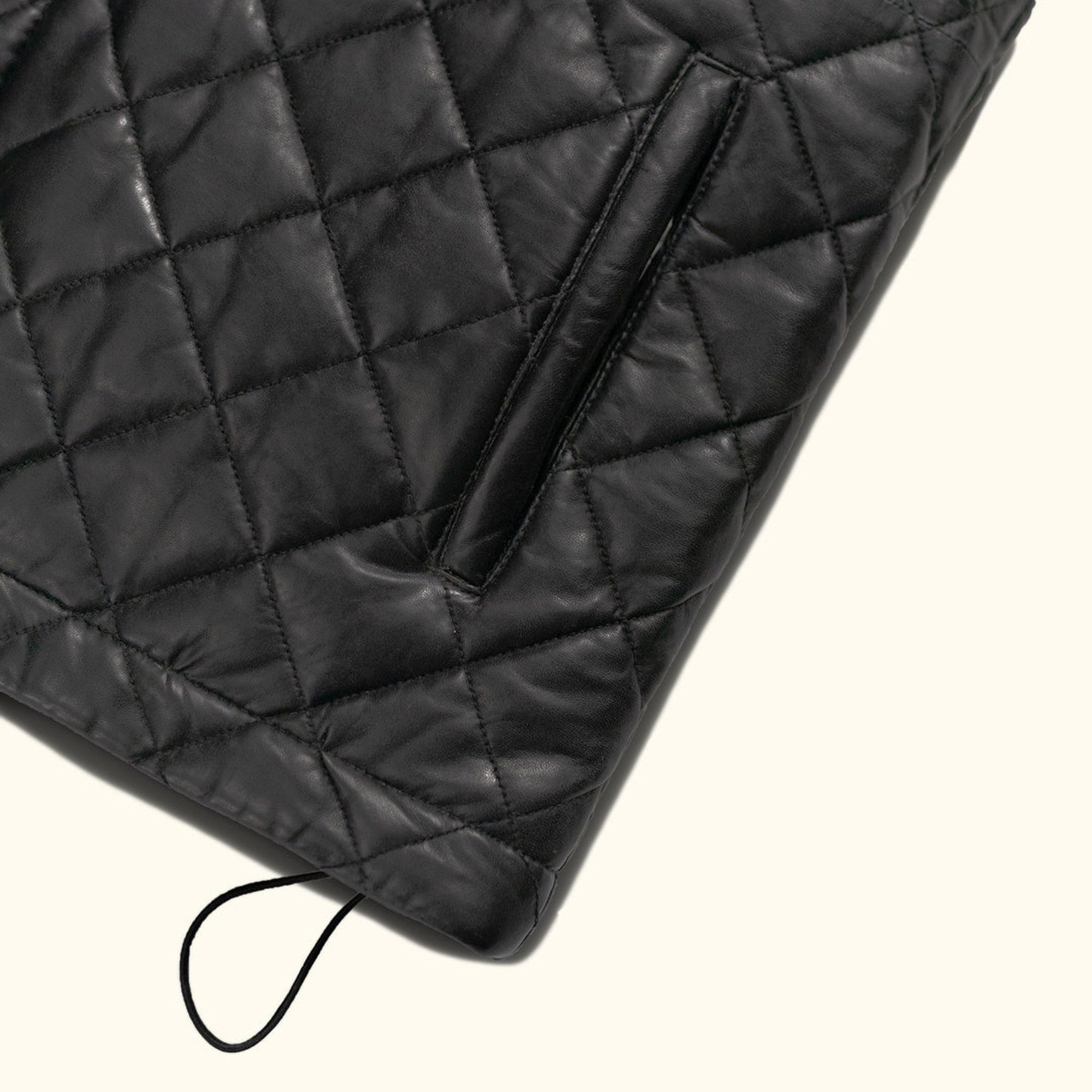 Highlands Quilted Leather Vest in Black, hem toggle detail.