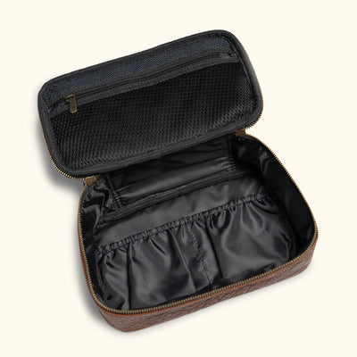 Fully open two-tone travel dopp kit displaying a spacious interior with black mesh and brown leather sections, ideal for organizing personal items.