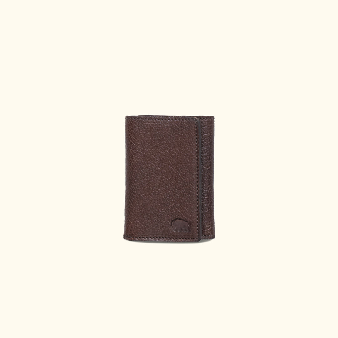 Dark brown Roosevelt bison leather trifold wallet with buffalo grain texture and compact design.