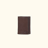 Dark brown Roosevelt bison leather trifold wallet with buffalo grain texture and compact design.