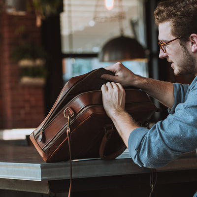 Sophisticated caramel leather briefcase, perfect for business professionals, with a secure zip closure