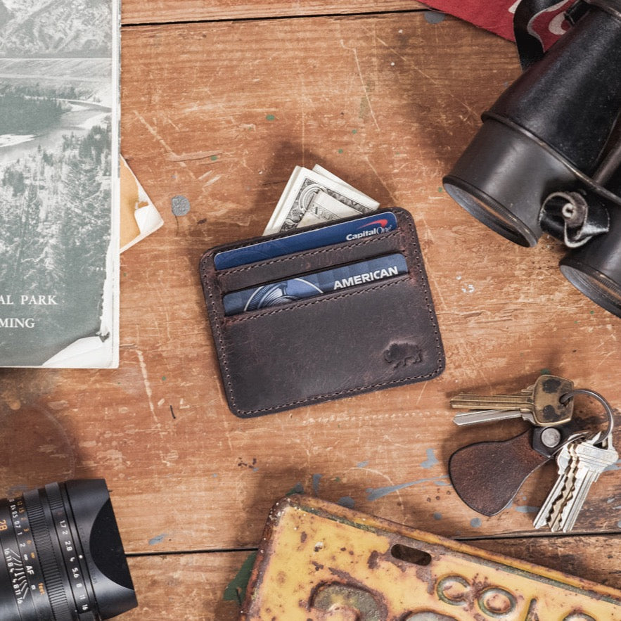 Dark oak Roosevelt leather slim ID wallet with visible stitching and embossed logo.