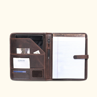 Inside view of dark oak leather travel padfolio revealing pockets and pen holder, designed for efficient document storage.
