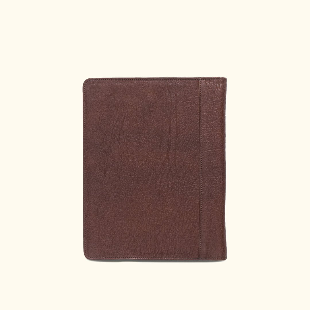 Classic dark buffalo grain leather padfolio, designed for travel with dedicated slots for business essentials.