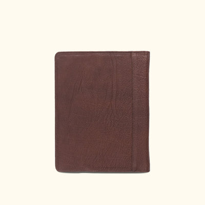 Classic dark buffalo grain leather padfolio, designed for travel with dedicated slots for business essentials.