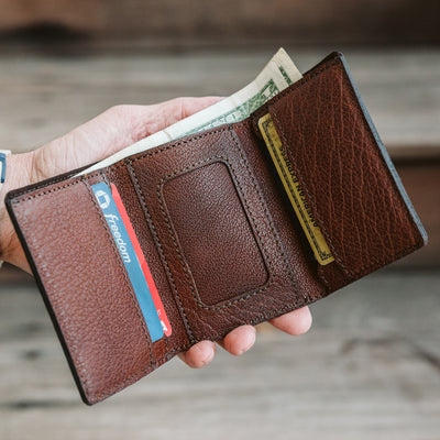 Rugged yet refined bison leather wallet in buffalo grain, designed for maximum storage in a trifold format.