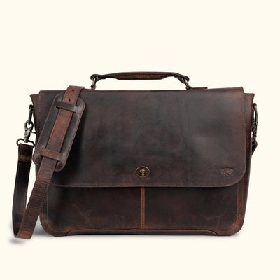 Rugged dark brown leather work bag with a spacious main compartment, ideal for carrying documents and tech essentials in style.