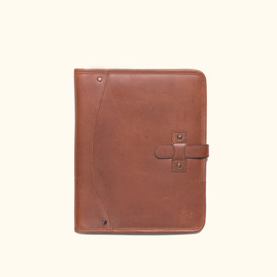Functional dark oak leather travel padfolio open to reveal storage pockets, pen holder, and a legal pad for notes.