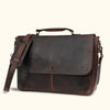 Vintage dark brown leather messenger bag with aged patina, featuring sturdy handle, adjustable strap, and classic front buckle closure.