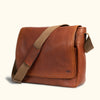 Elegant caramel leather messenger bag with contrasting brown textured patches and durable canvas shoulder strap for everyday elegance.