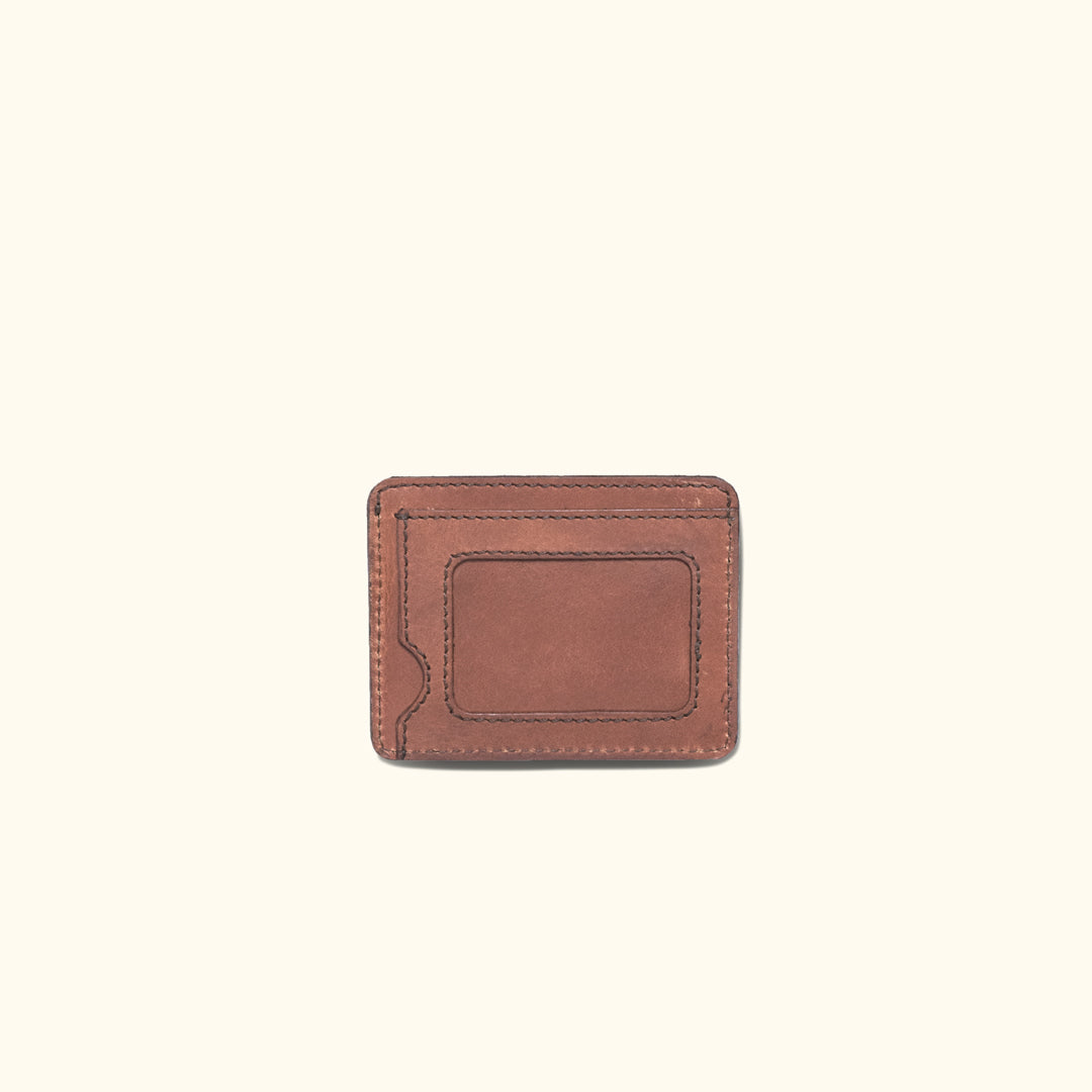 Amber brown Roosevelt slim ID leather wallet featuring a clear ID window and minimalist stitching.