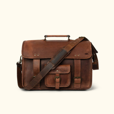 Rustic dark oak leather briefcase with multiple pockets, adjustable strap, sturdy handle, and embossed buffalo logo for professional use.