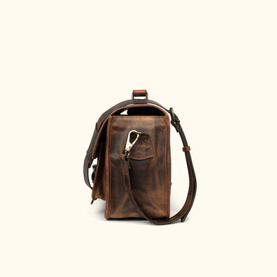Dark oak buffalo leather camera satchel featuring multiple compartments and secure buckle closures.