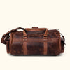 Luxurious dark oak leather duffle with detailed stitching, robust hardware, and comfortable carrying options for travelers.