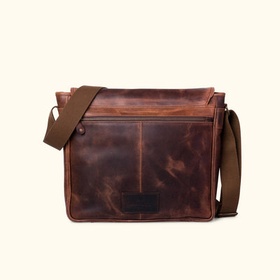 Dark oak brown leather messenger bag featuring a long zipper pocket on the back for secure, easy access to documents or a tablet.