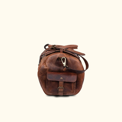 Side Angle - Men's travel duffle bag crafted from dark oak buffalo leather with reinforced stitching and multiple storage options.