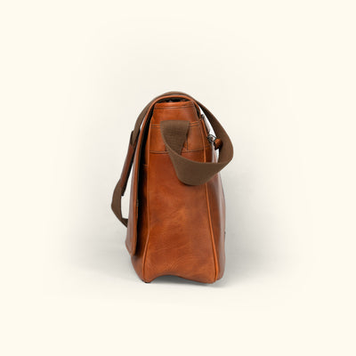 Stylish amber brown leather messenger bag with durable stitching and practical design.