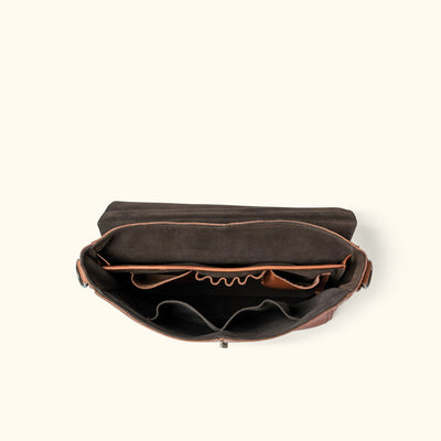 Open view of a brown leather messenger bag revealing internal compartments and organizers, ideal for professional and personal use.
