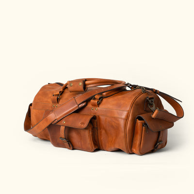 Durable Full Grain Leather Duffle: Autumn Brown, capacious, protective metal feet, premium stitching, timeless look for outdoor and urban adventures.